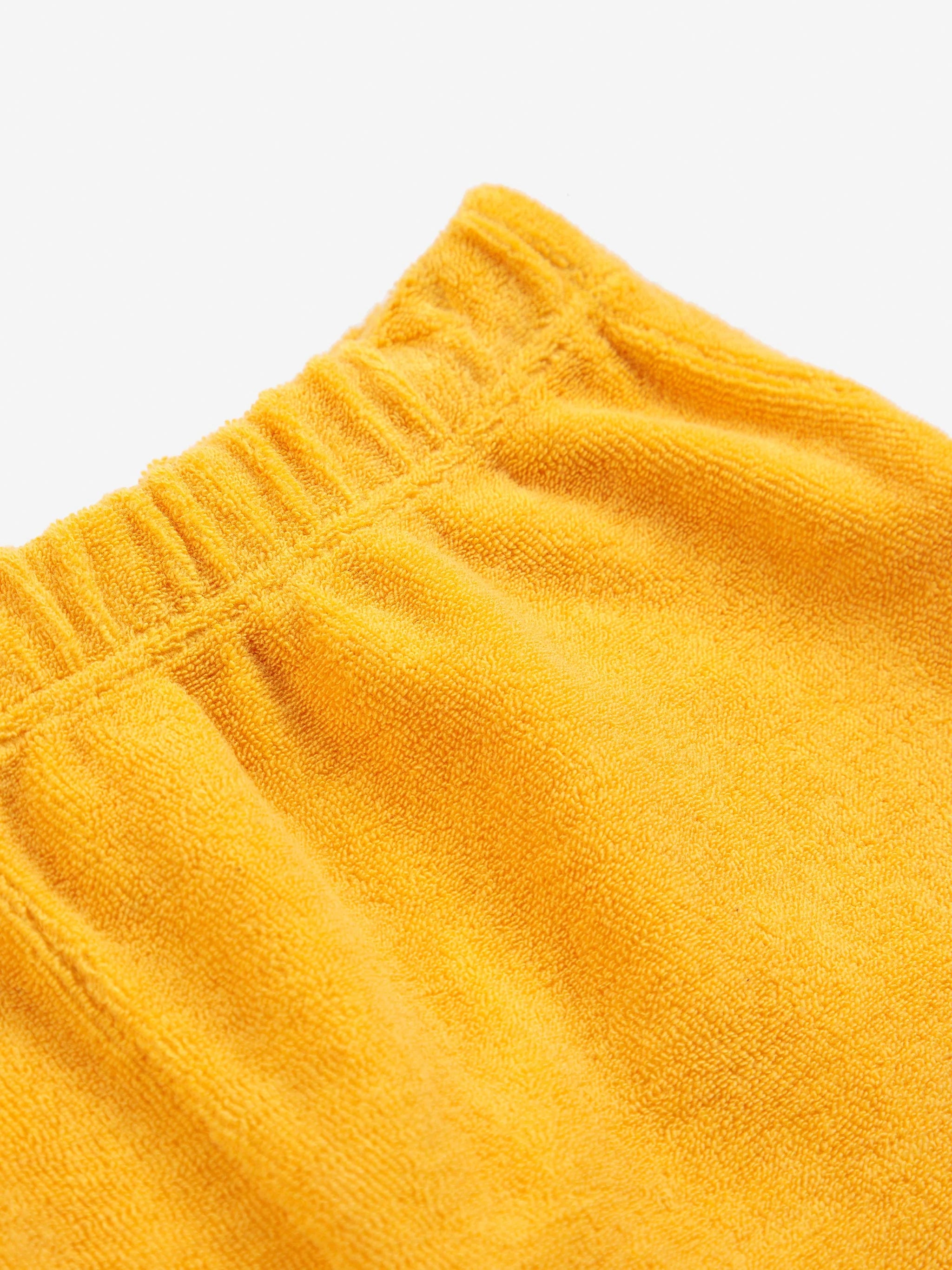bobo choses iconic collection baby poma yellow terry shorts