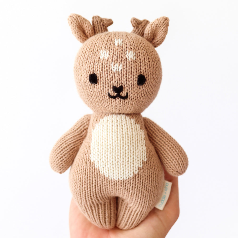 cuddle + kind baby fawn