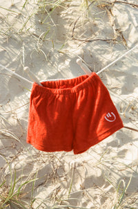 the wholesome store smiley terry towelling shorts - chilli