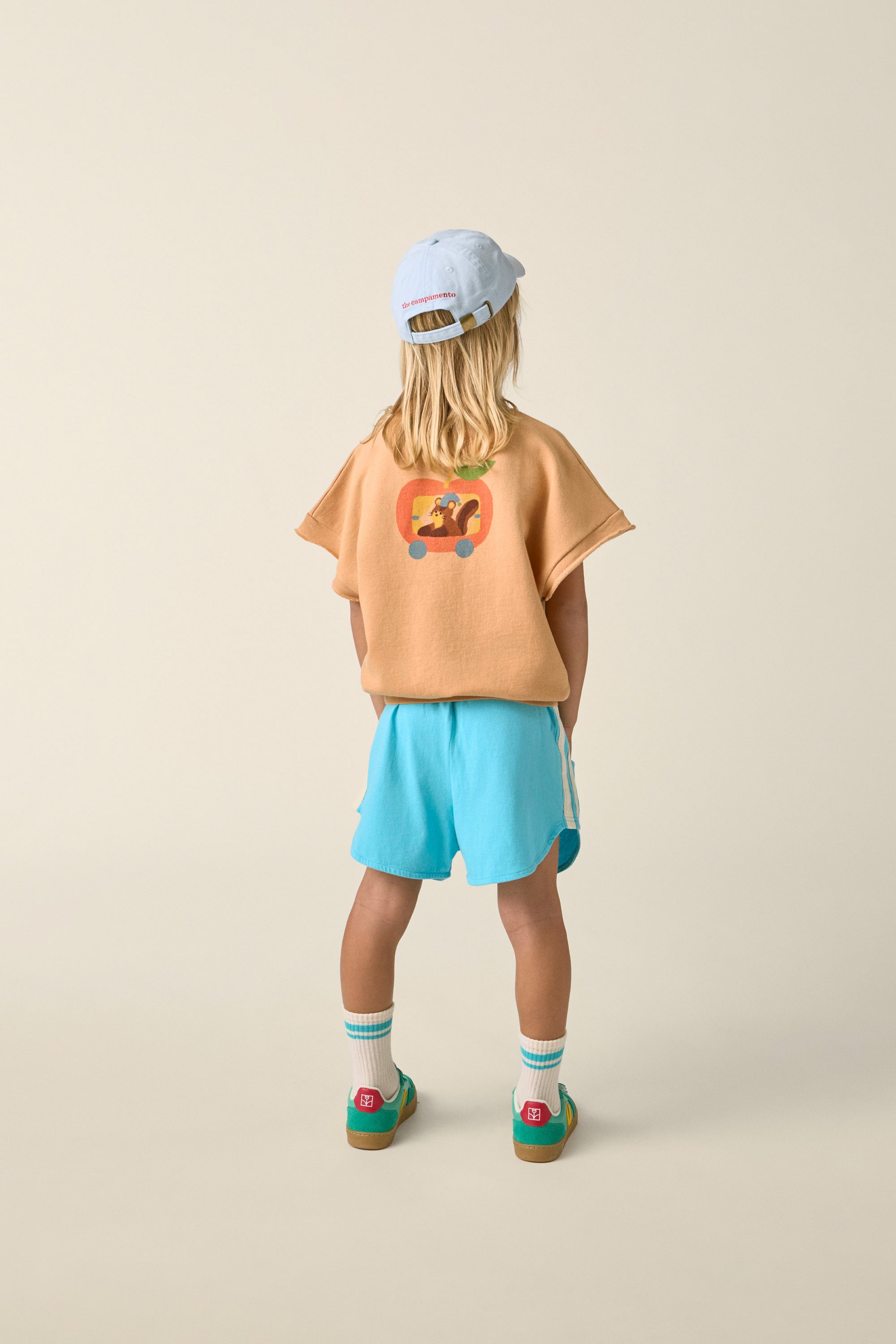 the campamento squirrel in an apple oversized vest